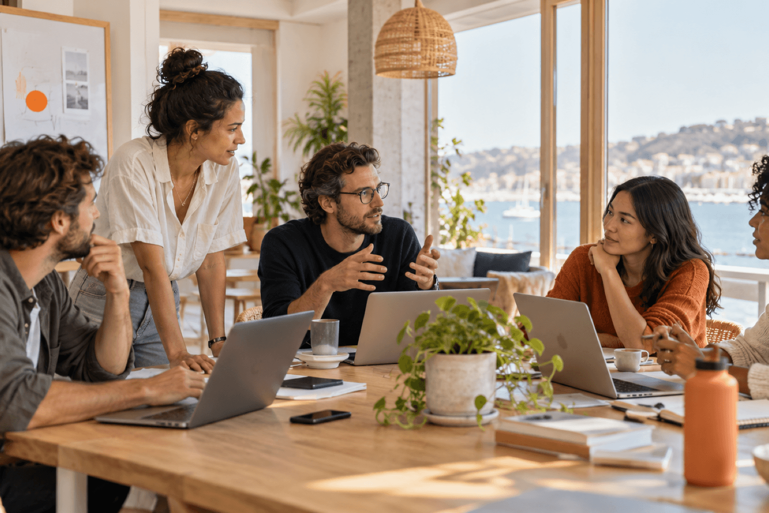 A small team working together around a table in a bright office